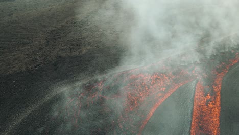 smoke coming from lava flows from pacaya volcano in guatemala - drone aerial