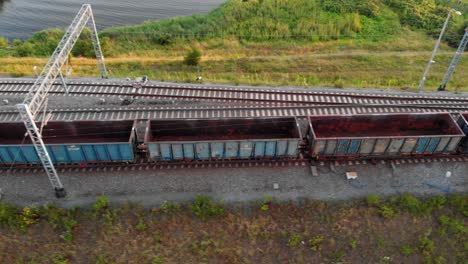 train with empty  cargo containers moving down tracks