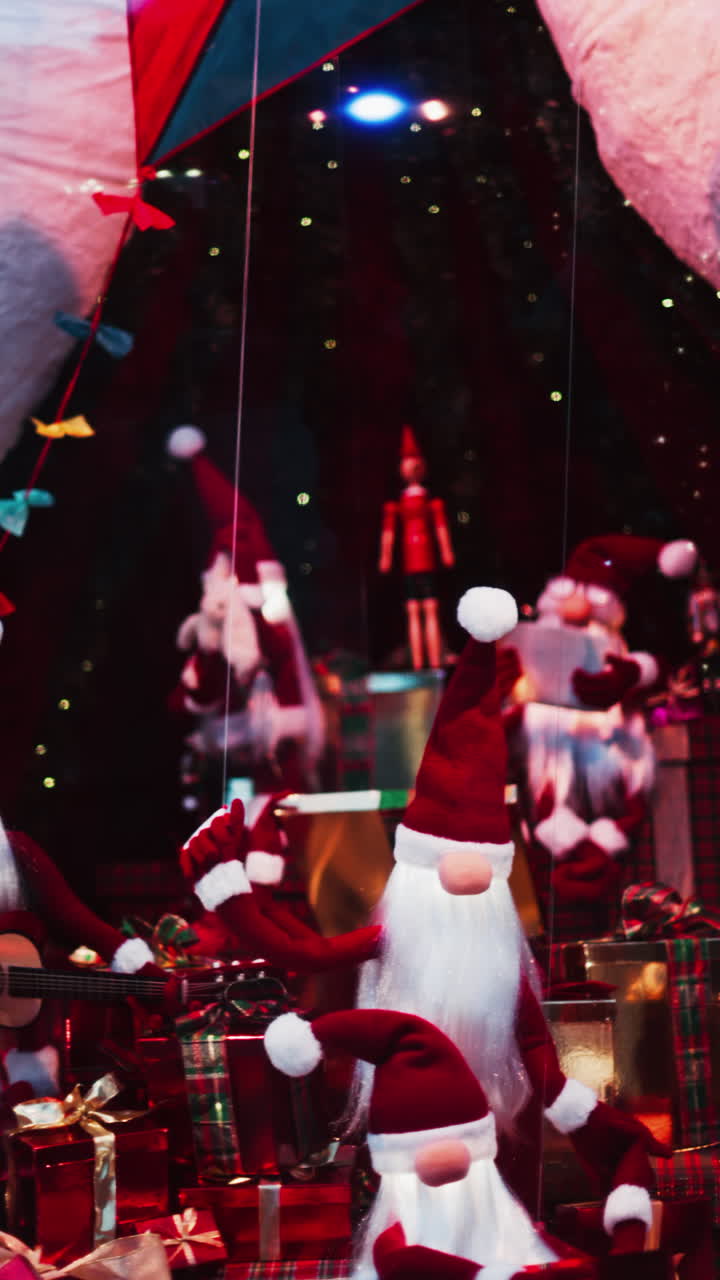 Multiple Santa Claus Christmas decorations moving in bubbles in the courtyard of the Monte Carlo Casino. Vertical