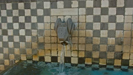 fountain with running water made of aries zodiac sign, camera motion view