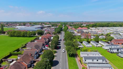 aerial view of a residential road with houses and mobile homes