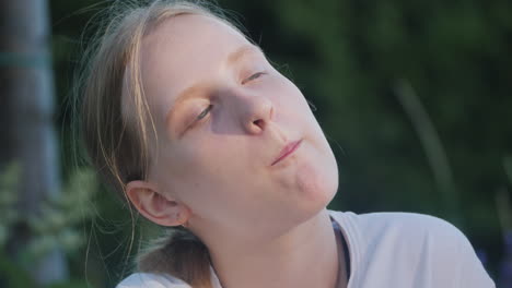 girl eating raspberry outdoors