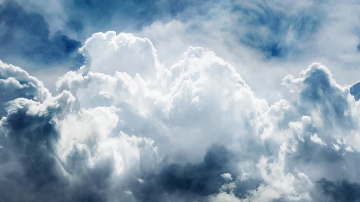 cumulonimbus clouds were thick and moving closer to the blue sky