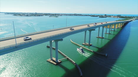 aerial shot of cars and boats on and around belleair bridge by clearwater beach, florida