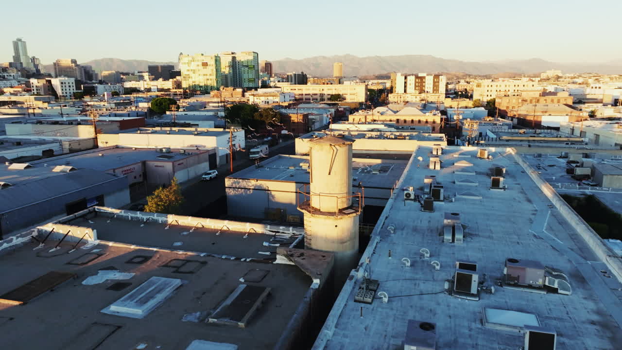 Aerial view of an urban landscape with a water tower at golden hour