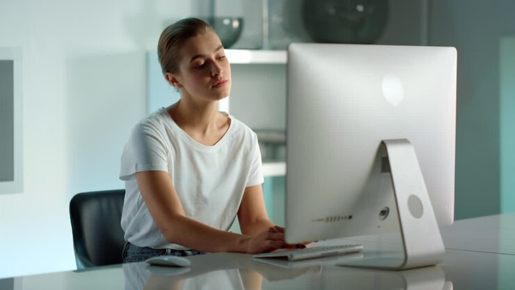Successful businesswoman typing desktop computer writing emails at home office.