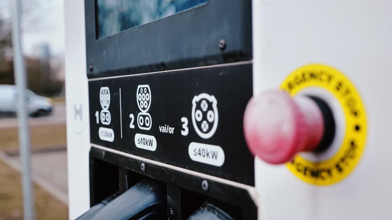 Camera slowly pulls away revealing EV charger details in subtle hand motion