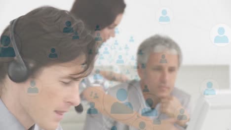 Animation-of-network-of-connection-with-icons-over-business-people-wearing-phone-headsets