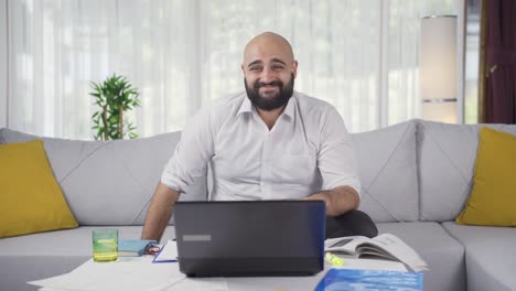 home office worker man looking smugly at camera.