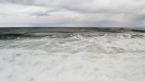 oceanfront view of ocean waves crashing on shore with overcast sky, neskowin oregon coast, usa