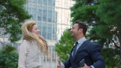 joyful business people jumping outdoor upon receiving good news and success. medium shot, slow motion