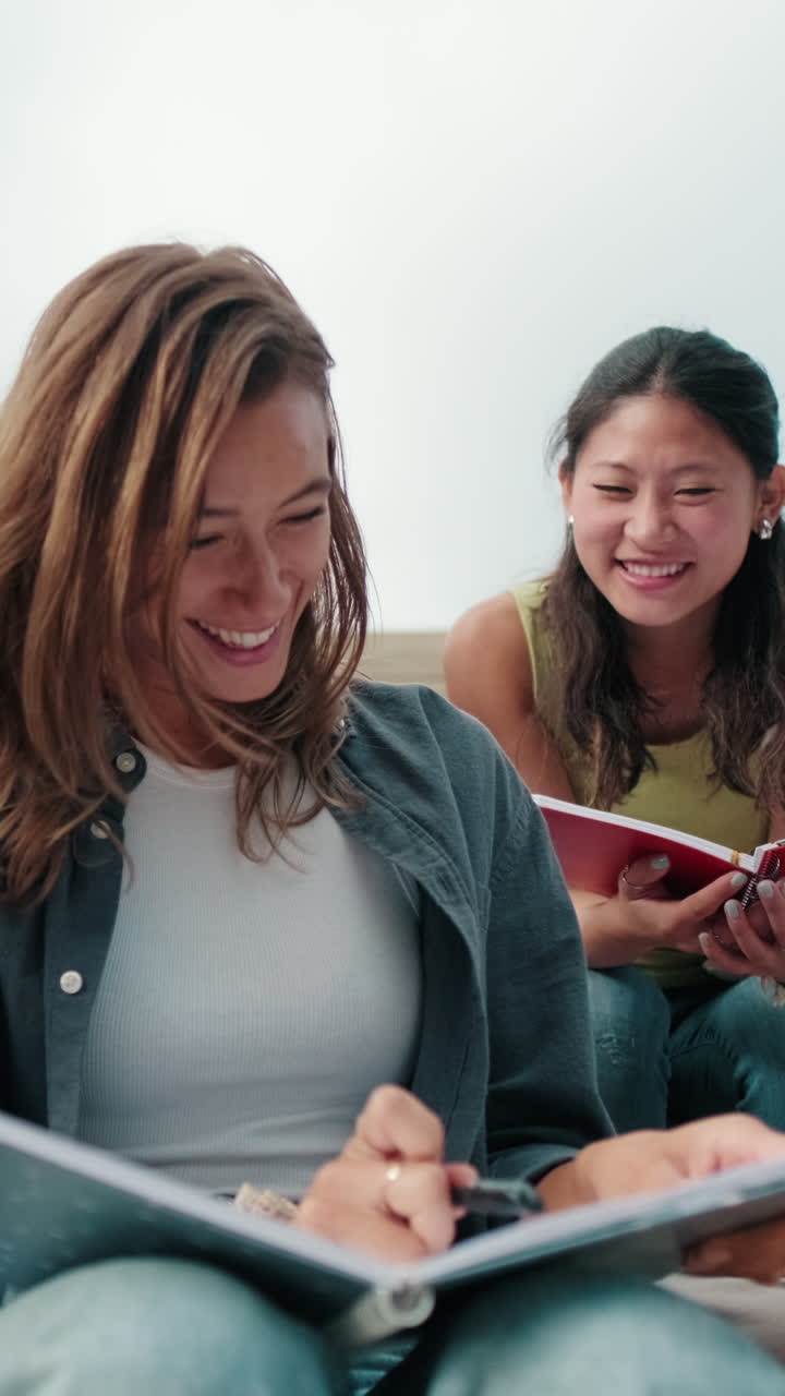 Close up view of the group of happy students with study items is sitting on the