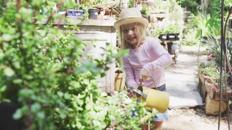 Little-girl-watering-plants-in-a-botanical-garden