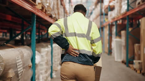 worker experiencing back pain in a warehouse
