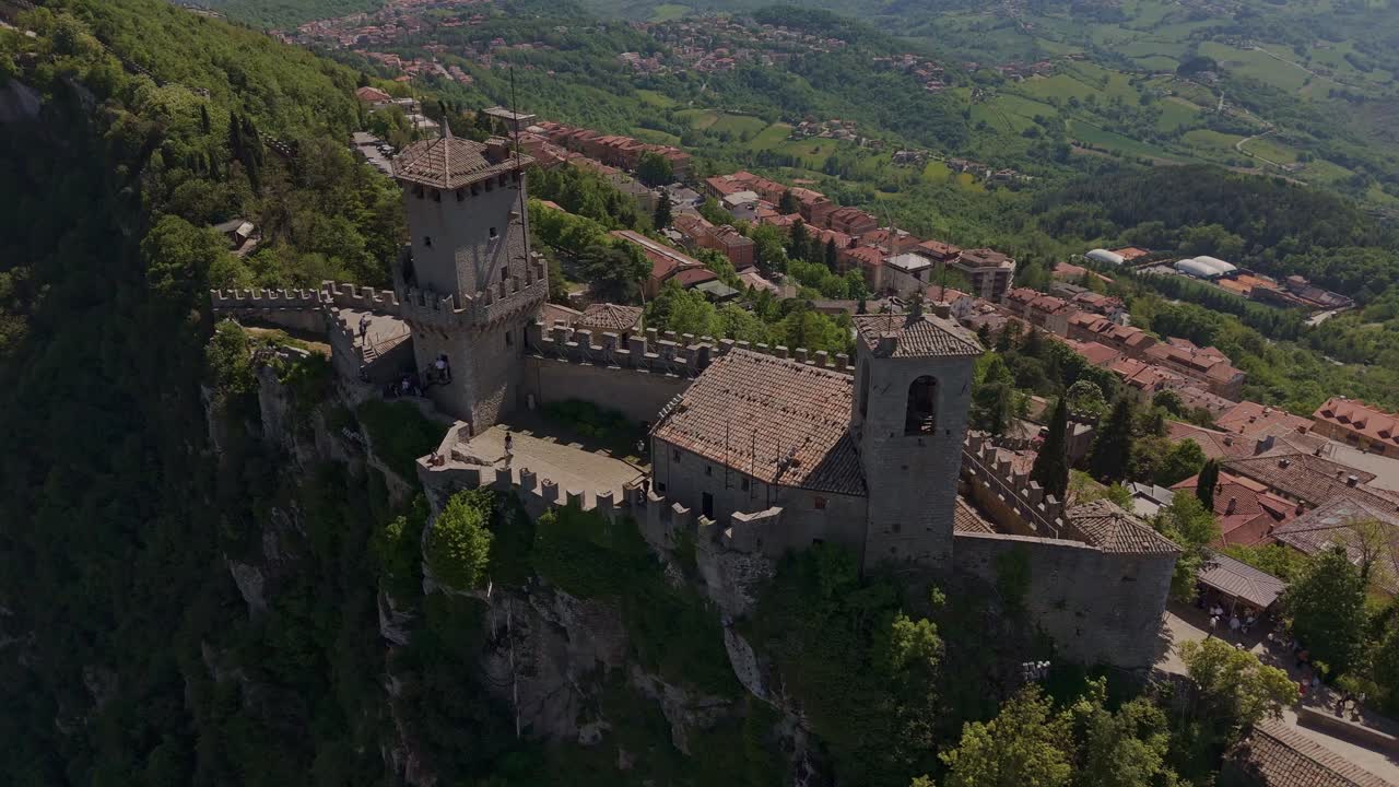 Aerial footage of the Guaita Tower (La Rocca), also known as Prima Torre, in San Marino. The medieval fortress sits atop Monte Titano, offering breathtaking views of the surrounding hills and city.