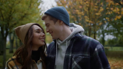 Young-couple-hugging-and-cuddling-together-outdoors-in-autumn-weather