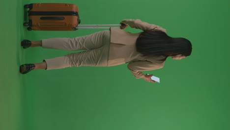 businesswoman with luggage on green screen