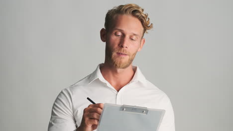 happy man writing on clipboard