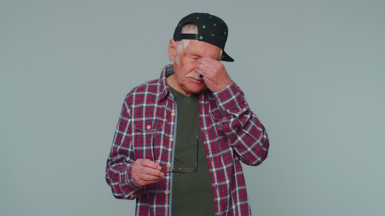 Exhausted tired man take off glasses feels eyes pain overwork burnout stress from long hours working