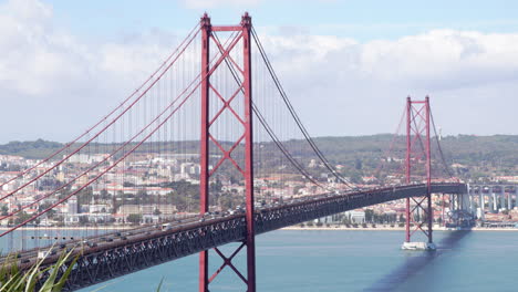 close up of 25 de abril bridge that's crossing tagus river in lisbon