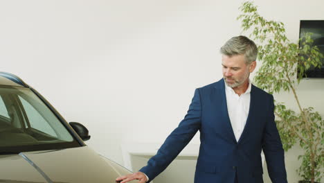 man looking at a new car in a dealership
