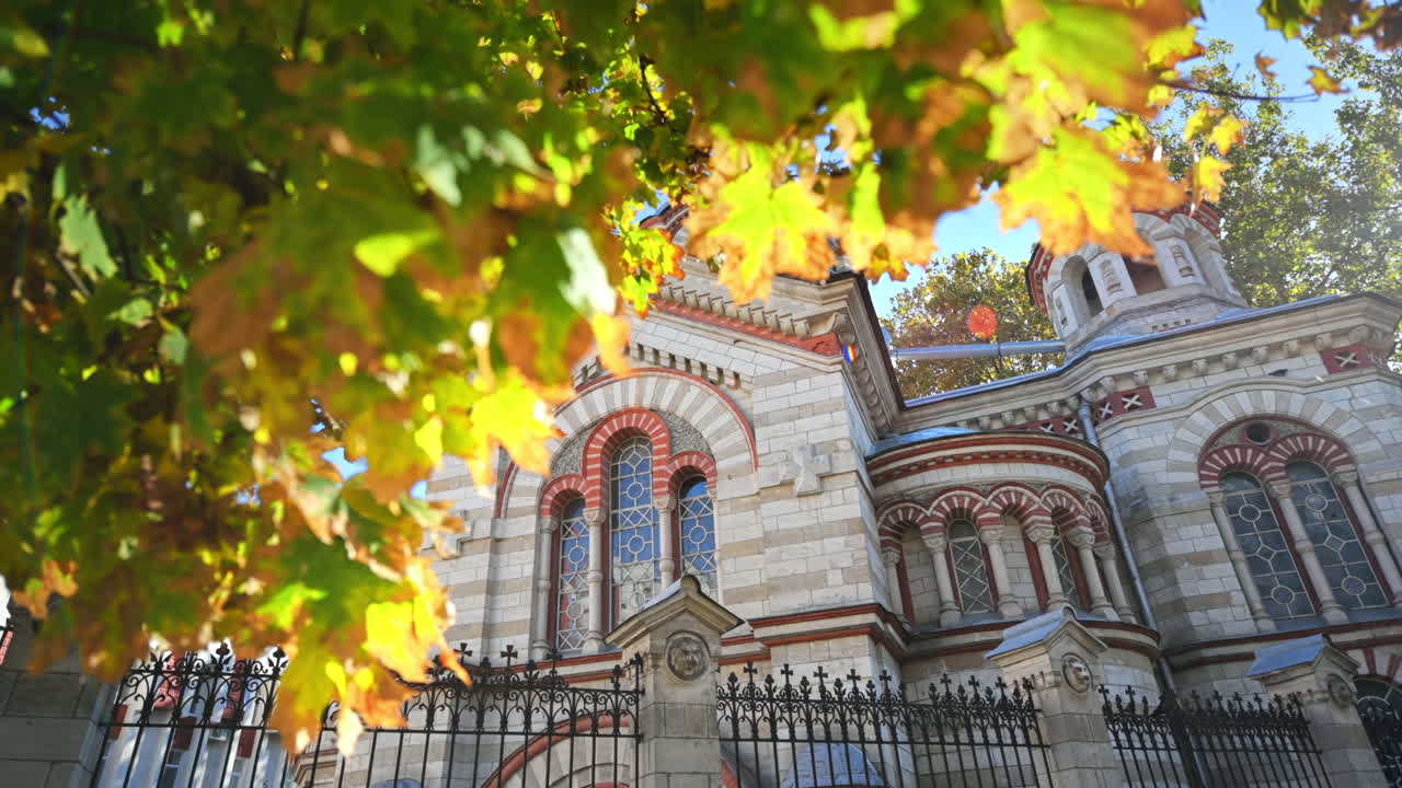 Saint Panteleimon Church in Chisinau, Moldova. Facade and court, yellowing trees around it