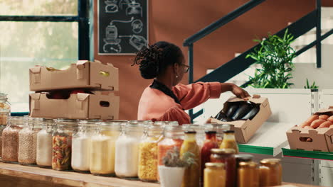 Seller-arranging-fruits-and-vegetables-in-crates-on-market-shelves