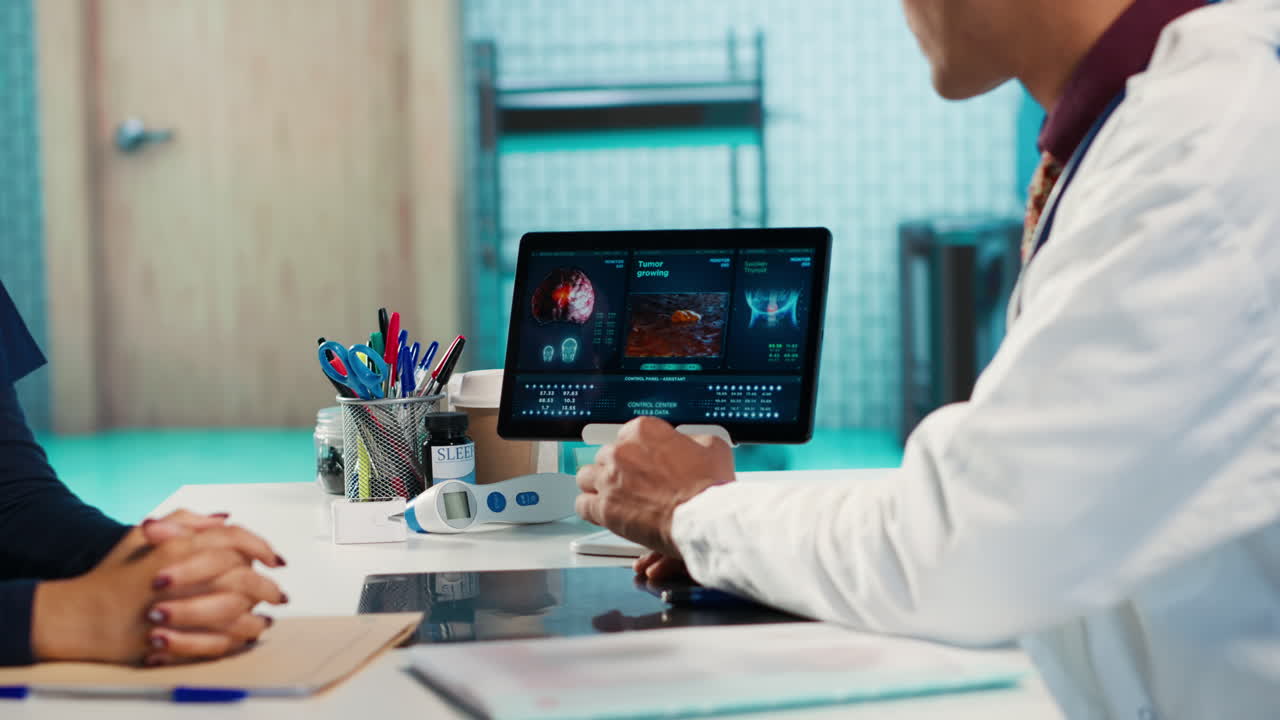 Doctor explaining tumor growth analysis to patient using a tablet