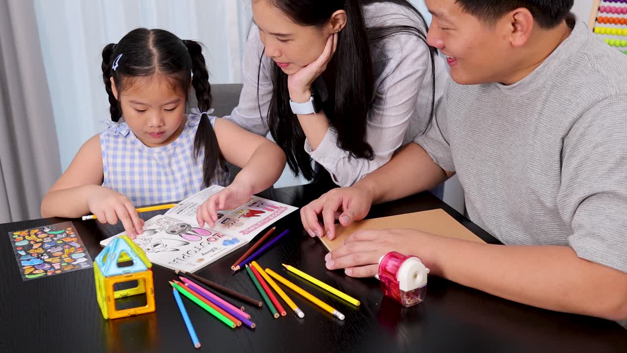 A family engages in drawing and painting together at a table, fostering creativity and connection in a bright, cheerful environment