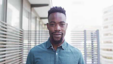 Portrait-of-happy-african-american-businessman-in-creative-office