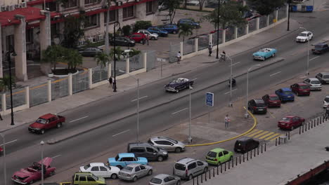 Vintage-Antique-Convertible-Cars-Drive-Past-Down-Below-in-Havana-Cuba