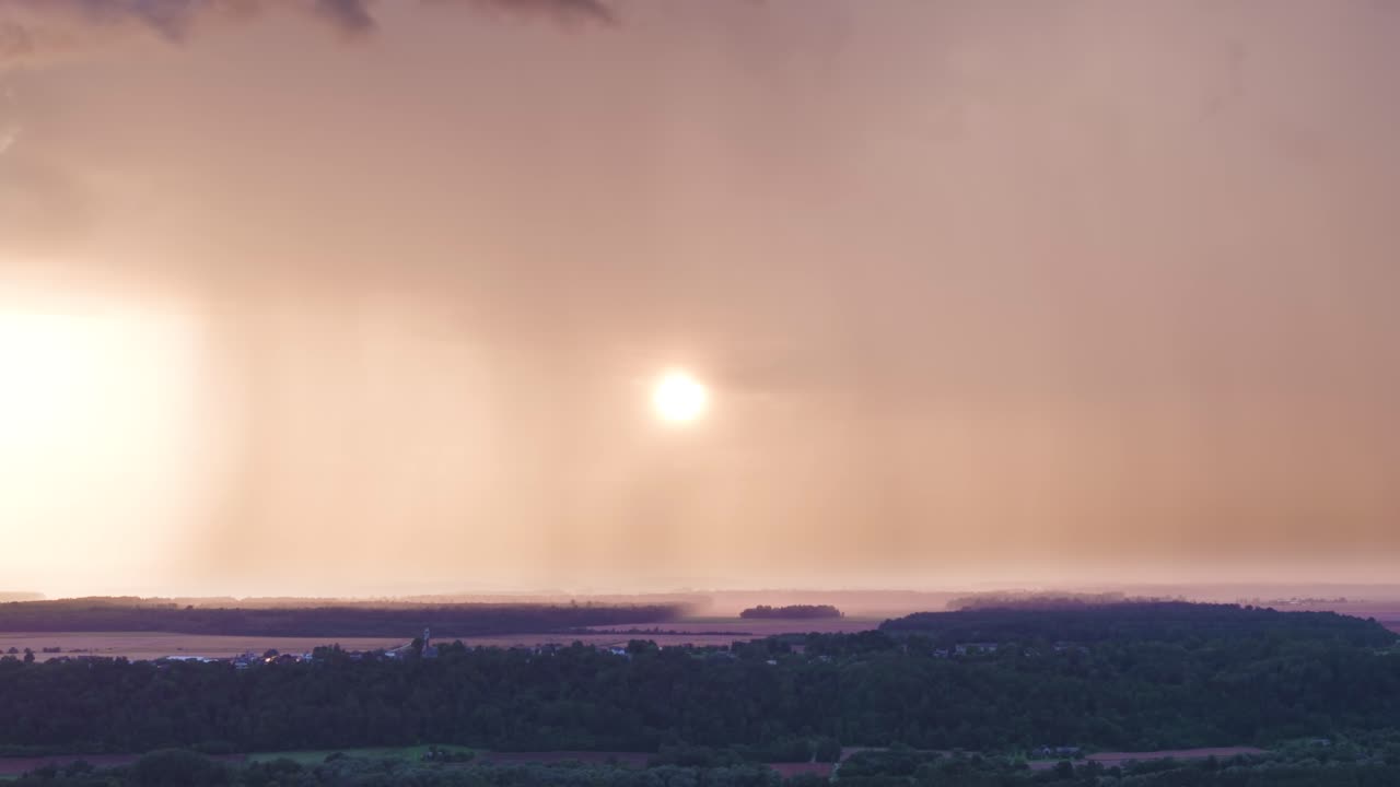 Bright sunset covered by rainfall, aerial view