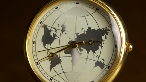 gold-plated wristwatch with a world map design