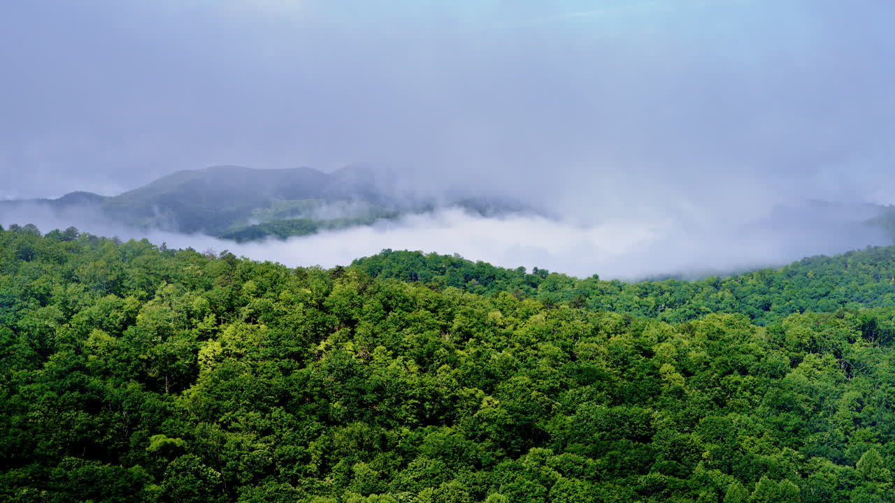 Mist swirls as a drone glides above the Smoky peaks