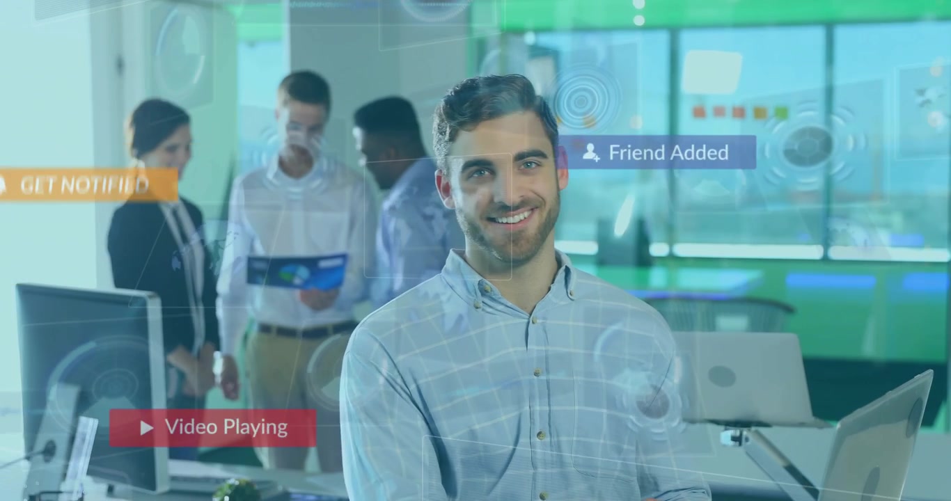 Businessman typing laptop in office, activating subscribe like and message icons floating, smiling