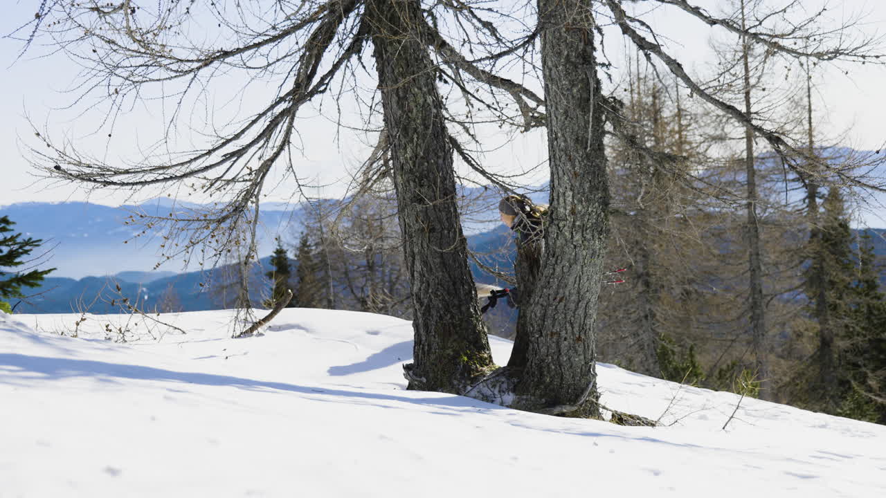 Woman and dog hiking in snowy mountains