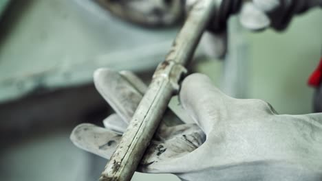 manufacturing parts for production. close up view of mechanical parts in hand of worker