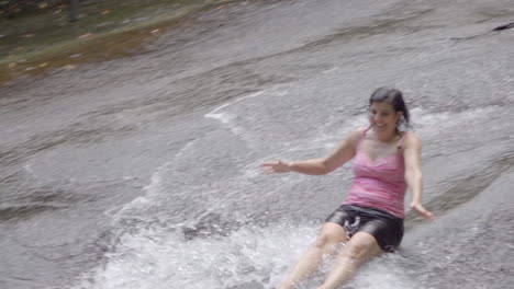 woman going down sliding rock in north carolina