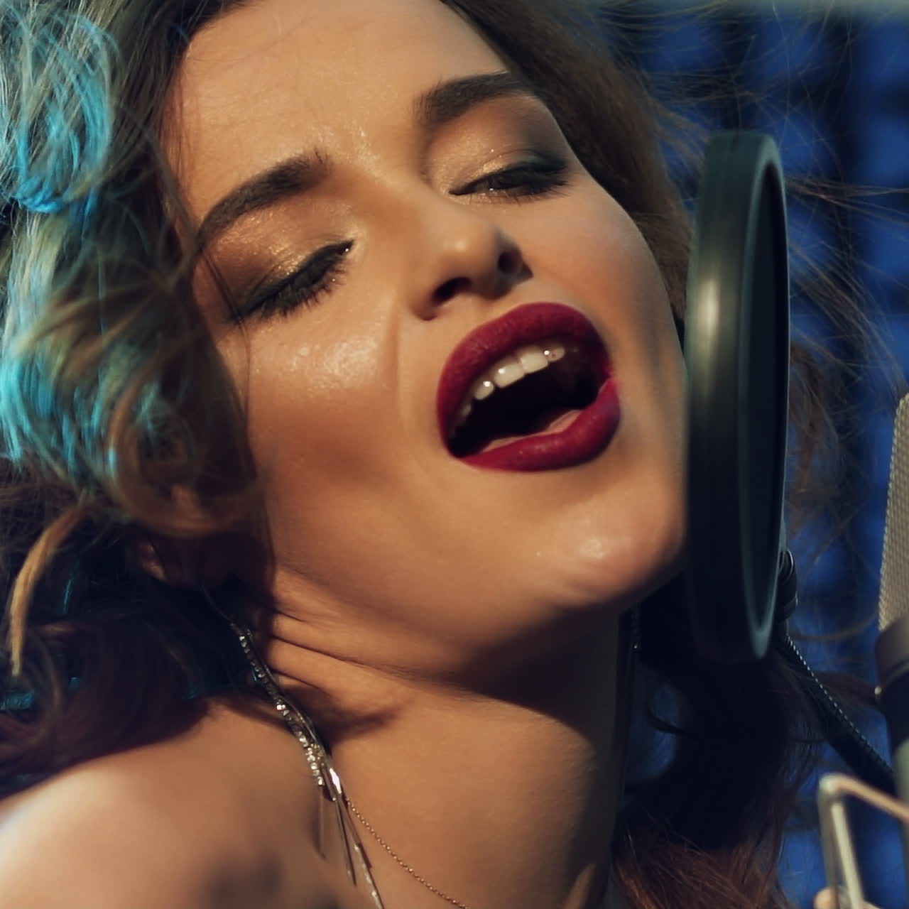 Woman singing in a recording studio. Female vocals. Professional recording studio.