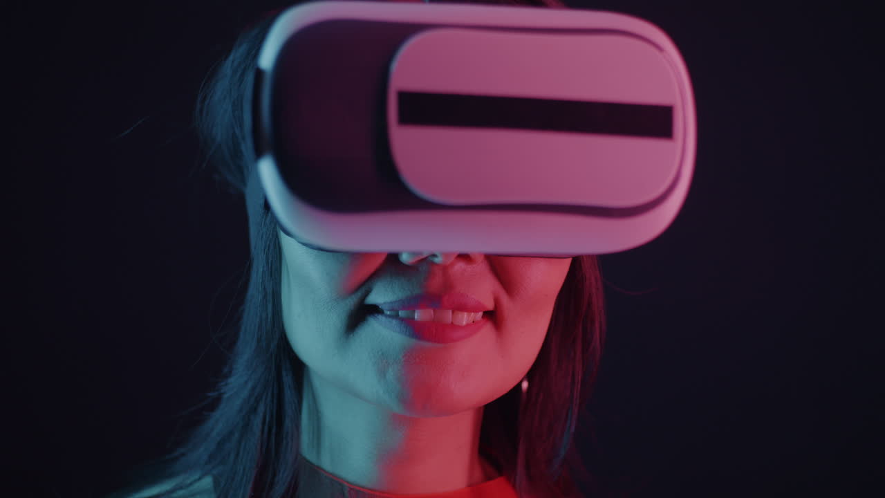 Woman wearing VR headset in neon lighting