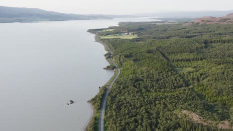 Green-Hallormsstaður-National-Forest-with-lake-Lagarfljót-in-Iceland,-aerial