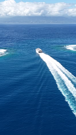French Polynesia. Vertical Drone Shot of Ferry Boat Moving by Coral Reefs Barrier Between Moorea and Tahiti