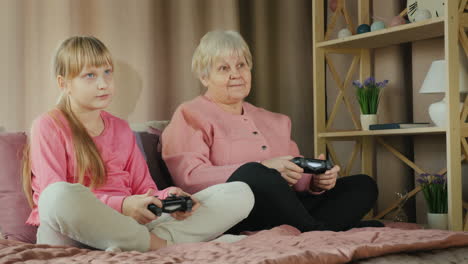 grandmother and granddaughter play video games together