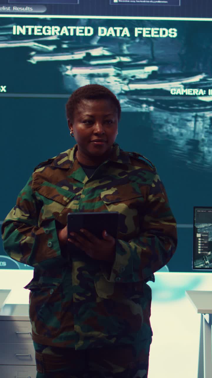 Female Soldier in Camouflage Uniform Using Tablet in Control Room
