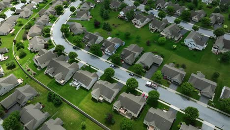 aerial top down of noble housing area with high class single family houses and green grass in garden. similar homes in residential area of american town. quiet suburb community in spring season.