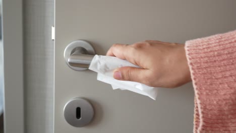 Cleaning-door-knob-with-tissue-close-up