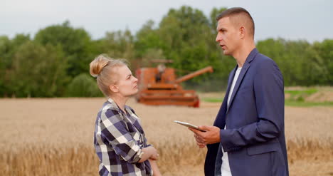 young farmers discussing at wheat field 25