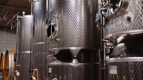 stainless steel wine fermentation tanks in modern wine-cellar