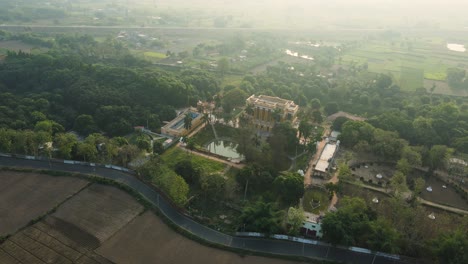 drone shot of katra masjid in murshidabad, surrounded by greenery and reflecting its historical elegance.