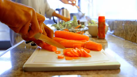 Couple-preparing-food-in-kitchen-at-home-4k